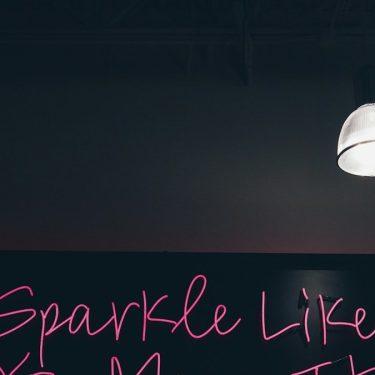 black and pink Sparkle like you mean it signage