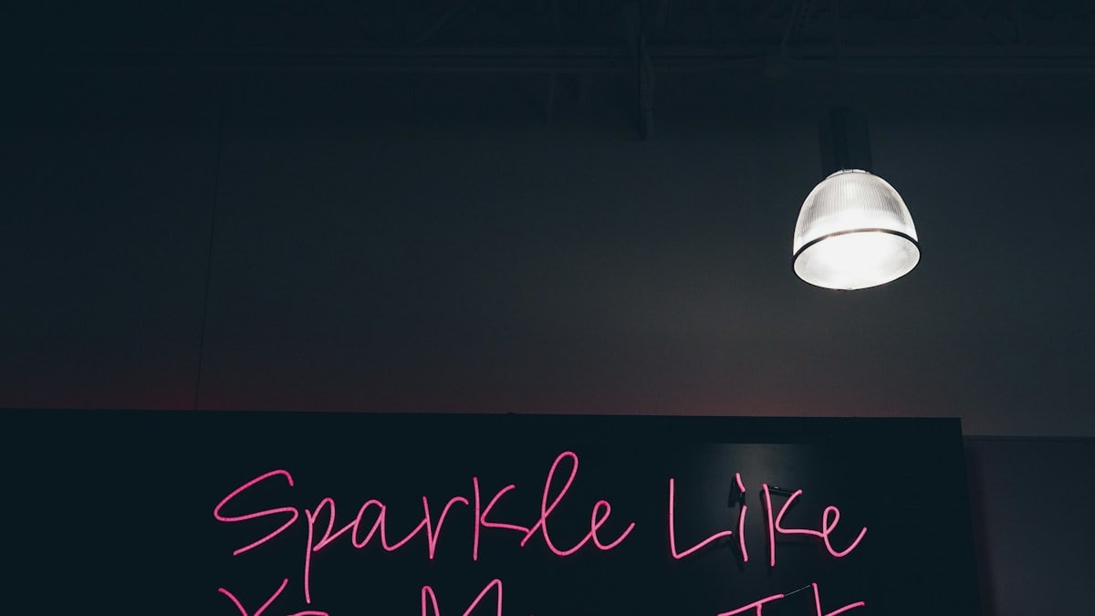 black and pink Sparkle like you mean it signage